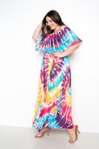a woman wearing a colorful tie dye maxi dress